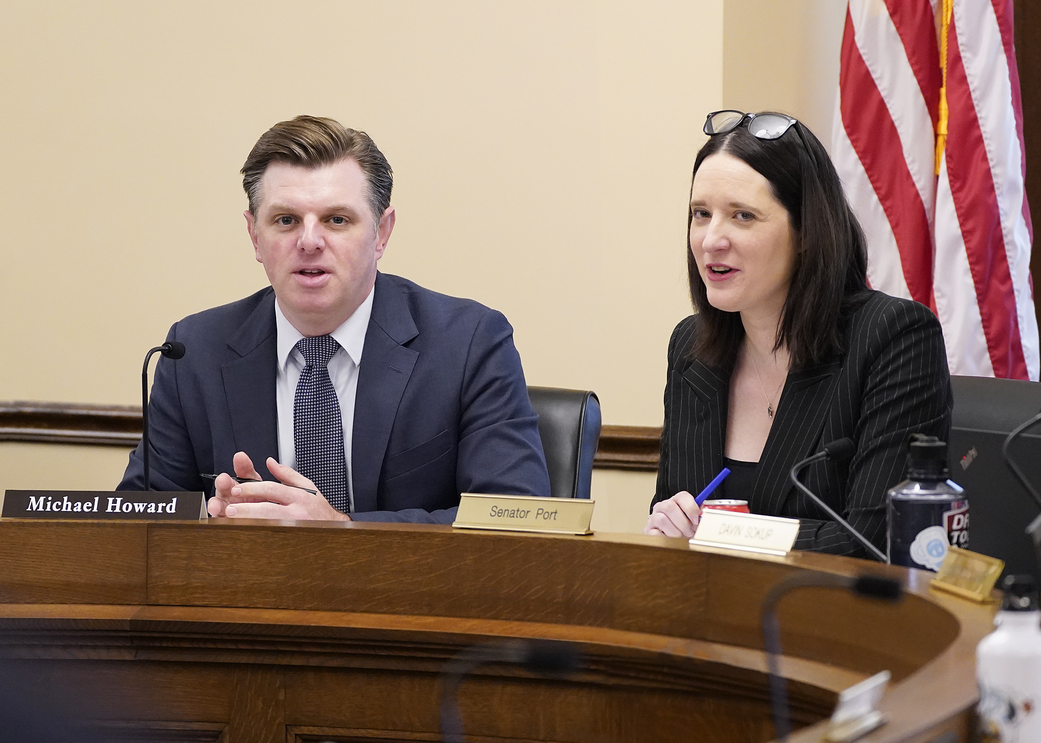 Rep. Michael Howard and Sen. Lindsey Port listen as staff do a walkthrough of the spreadsheet and side-by-side comparison during the first meeting of the omnibus housing bill conference committee. (Photo by Andrew VonBank)